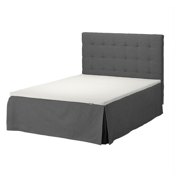 SKOTTERUD grey bed with cushioned headboard and white mattress.