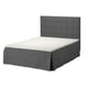 SKOTTERUD grey bed with cushioned headboard and white mattress.
