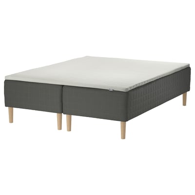 IKEA SKOTTERUD bed: dark grey, wooden legs, rectangular, quilted base, white mattress top.