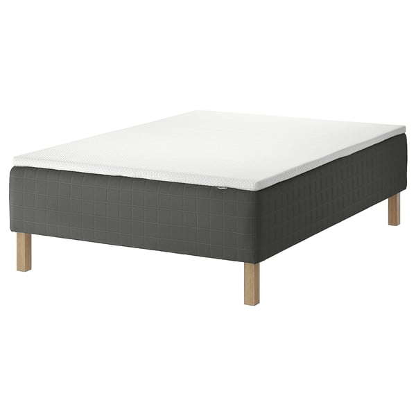 Single bed with white mattress, dark gray fabric base, four light wood legs.