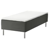 The SKOTTERUD sprung mattress in black with stainless steel legs, showcasing a modern and minimalist design for comfortable and supportive sleep.