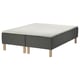 An ikea SKOTTERUD bed frame in black with wooden legs. It supports a white mattress.