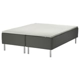 SKOTTERUD bed: a modern, dark grey, upholstered platform bed with a rectangular, white mattress. It metal legs, a quilted texture, and a sleek design.