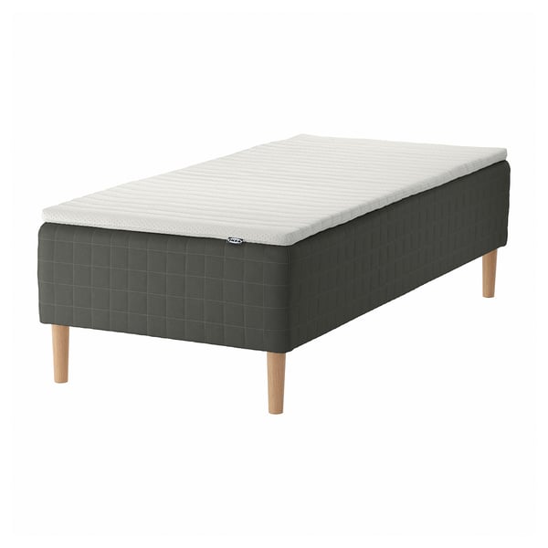SKOTTERUD bed; dark gray quilted fabric, wooden legs, white mattress top.