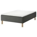 SKOTTERUD bed: black sprung mattress, white top, wooden legs. Quilted design for comfort.