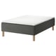 SKOTTERUD bed: black sprung mattress, white top, wooden legs. Quilted design for comfort.