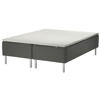 SKOTTERUD bed base in dark grey with metal legs, supporting a white mattress.