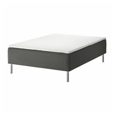 A SKOTTERUD bed with a white top and dark grey base, featuring white legs.