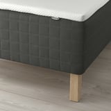 Bed with SKOTTERUD sprung mattress, textured top, ikea tag.