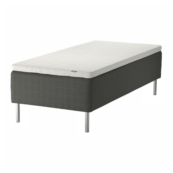 SKOTTERUD bed in white & dark grey, quilted, raised on metal legs.