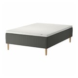 A SKOTTERUD bed with a white mattress on a dark grey base and wooden legs.