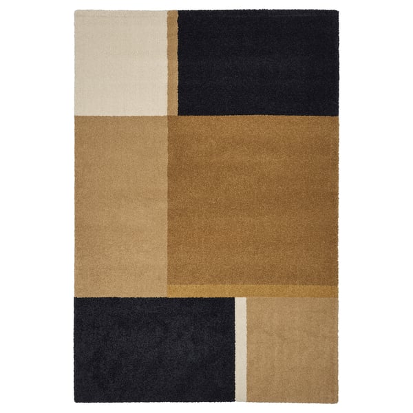 The SKRIFTSPRÅK rug bold, rectangular shapes in earthy tones, creating a luxurious and sound-dampening addition to your room.