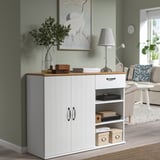 White SKRUVBY sideboard with wooden top, drawers, shelves, green wall art, lamp, cozy living room.