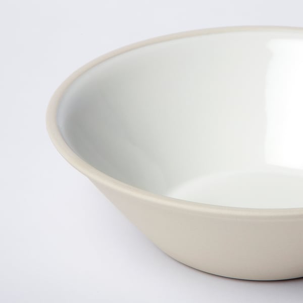 Smooth, handmade stoneware bowl in soft white, set against a white background.