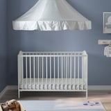 Baby crib: SMÅGÖRA white, wood, canvas canopy, fitted sheet, soft mat, toys. Cozy and compact.