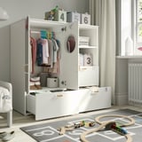 A childs room with a SMÅSTAD wardrobe displaying clothes, books, and toys, promoting independent play and organization.