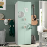 Green SMÅSTAD wardrobe with mirror, soft-close doors, guitar, chair.