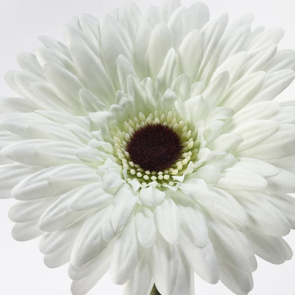 Close-up of lifelike artificial white gerbera. Crafted with polyester, polyethylene, and steel for durability. Petals appear fresh and detailed.