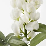 Lifelike white artificial flowers with green leaves, made from recycled materials.