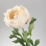 Artificial white flower with green leaves. Crafted from recycled materials, looks realistic.