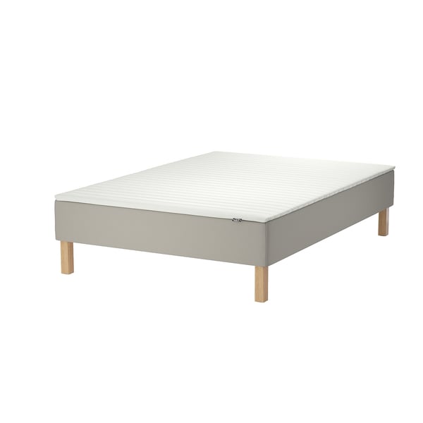 A white SNARUM bed with wooden legs.