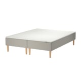 Ikeas SNARUM bed: rectangular, light gray, fabric-covered base with wooden legs.