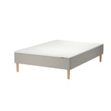 Grey modular bed frame, light wood legs, minimalist design.