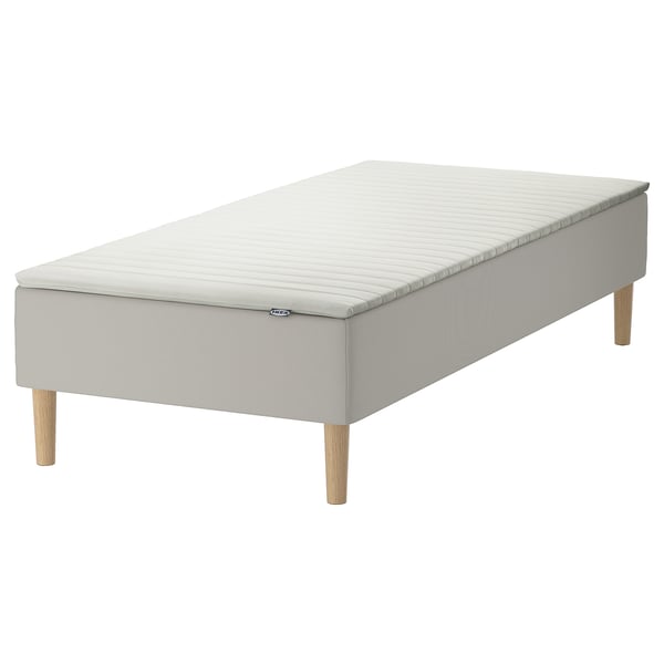 SNARUM grey mattress base with light wooden legs.