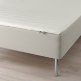 White bed on legs, ikea tag visible.