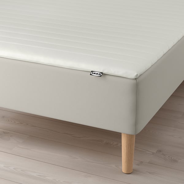 IKEA bed base with natural legs, supporting bonnell springs for comfort.