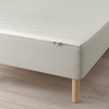 IKEA bed base with natural legs, supporting bonnell springs for comfort.