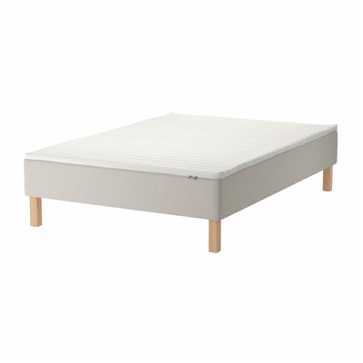 White bed base with wooden legs.