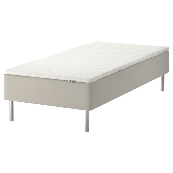 Ikea SNARUM bed: white, upholstered, rectangular, four metal legs.