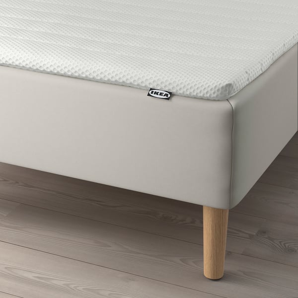 Bed with ikea mattress, supportive bonnell springs, and wooden legs.