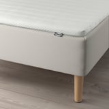 Bed with ikea mattress, supportive bonnell springs, and wooden legs.