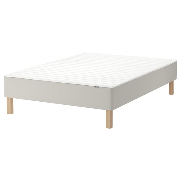 White SNARUM bed base, light wood legs, supportive bonnell spring mattress.