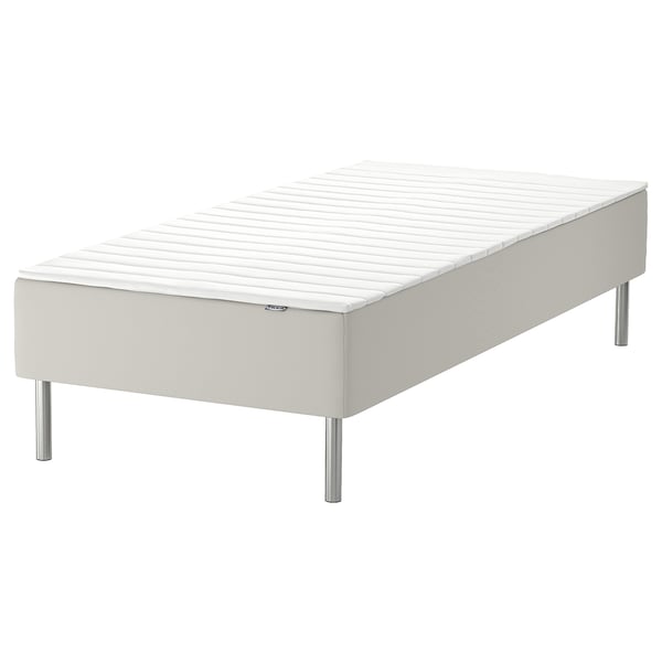 White bed base with metal legs.