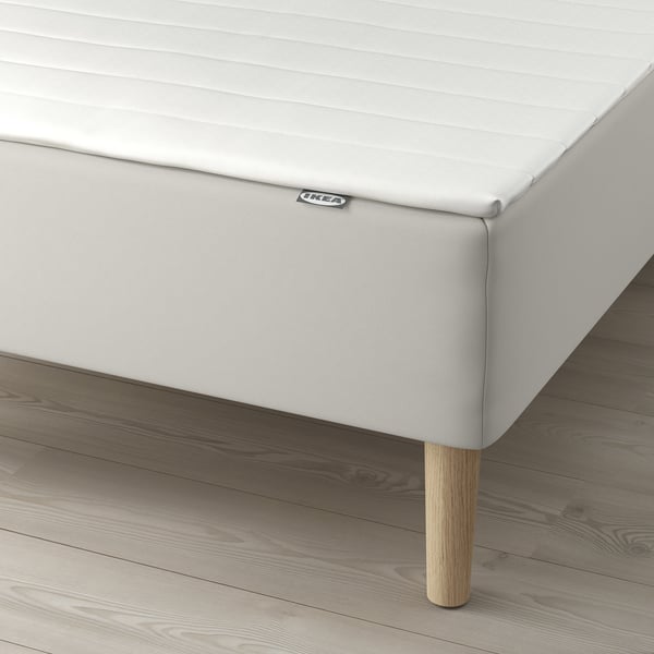 IKEA bed with bonnell spring support; includes wooden legs and mattress topper.