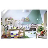 Childs room with SNIGLAR beech wooden bed, colorful rug, play table, toys, and shelves. Bright and playful decor.
