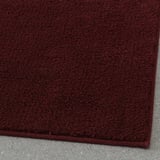 Thick, plush burgundy bath mat with latex backing, providing soft comfort and secure footing.