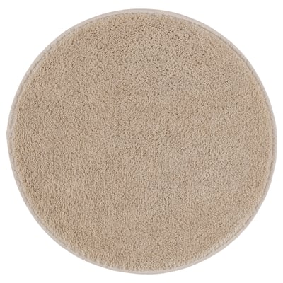 Round, beige SÖDERSJÖN bath mat, soft cotton pile, latex back, simple design.
