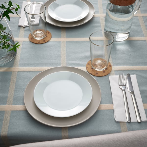 Table set with SOLABBORRE cork place mats, white plates, glasses, and cutlery. Cork coasters protect plates and table.