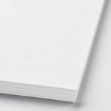 Stack of thick, white, textured art paper pads; ideal for drawing or painting.