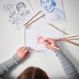 Artist uses SOLFÅGEL pencils on paper, creating detailed artwork. Various completed and in-progress drawings showcase rich pigment and ease of use.