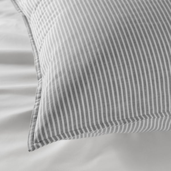 Gray striped cotton pillow showcasing intricate stitching detail, highlighting soft, high-quality fabric.