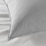 Gray striped cotton pillow showcasing intricate stitching detail, highlighting soft, high-quality fabric.