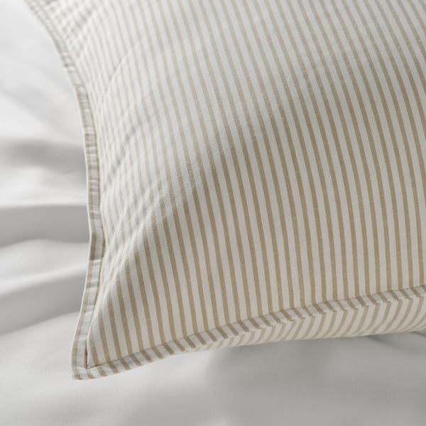 Striped pillow with gentle, high-quality fabric resting on another pillow, showcasing its soft, inviting texture.