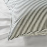 Striped cotton pillow with precise stitching, showcasing quality craftsmanship and natural texture.