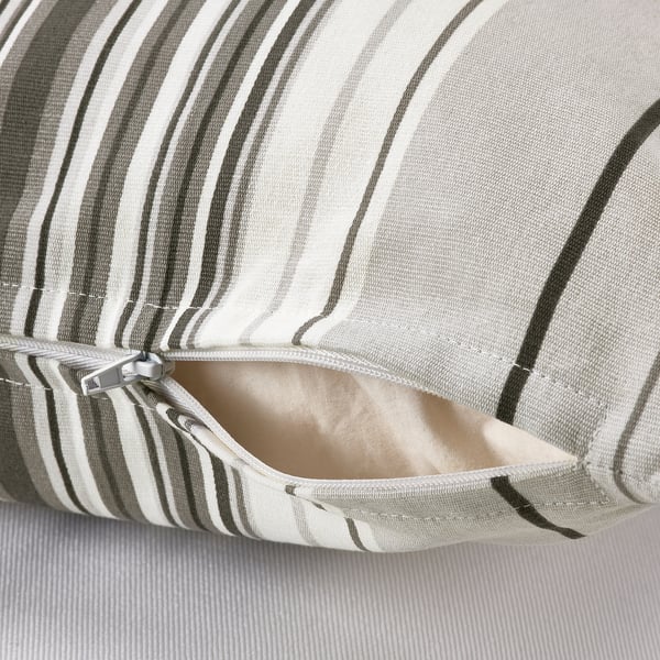 Close-up of striped cushion cover with open zipper showing inner lining.