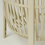 Modern lamp with intricate, curved slats. Light-colored, stylish design.